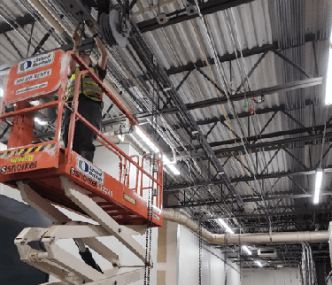 Tech on Lift Installing Bike Rack